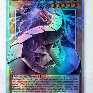May include: A holographic trading card featuring a mechanical dragon with a futuristic design. The card is titled "REVOLUTION CYBER DRAGON" and includes game text. The dragon is primarily silver, with blue and purple accents. The card's ATK is 2100 and DEF is 1600.