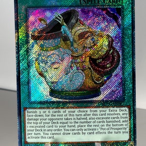 May include: A holographic Yu-Gi-Oh! trading card featuring a blue and gold pot with a red lid. The card is titled "Pot of Prosperity" and has the text "Banish 3 or 6 cards of your choice from your Extra Deck, face-down; for the rest of this turn after this card resolves, any damage your opponent takes is halved, also excavate cards from the top of your Deck equal to the number of cards banished, add 1 excavated card to your hand, place the rest on the bottom of your Deck in any order. You can only activate 1 "Pot of Prosperity" per turn. You cannot draw cards by card effects the turn you activate this card."