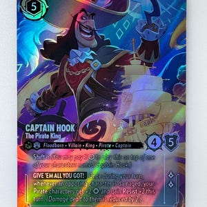 May include: A Captain Hook trading card from Disney Lorcana. The card features an illustration of Captain Hook with a ship in the background. The card has a holographic finish and includes the text "GIVE 'EM ALL YOU GOT!"