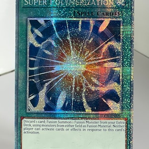 May include: A holographic trading card for the game Yu-Gi-Oh! featuring the spell card "Super Polymerization". The card has a blue background with a holographic image of a shattered sphere in the center. The card text reads "Discard 1 card; Fusion Summon 1 Fusion Monster from your Extra Deck, using monsters from either field as Fusion Material. Neither player can activate cards or effects in response to this card's activation."