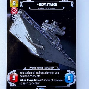 May include: A black and white card game card featuring a large spaceship with the text "DEVASTATOR" and "HUNTING THE REBELLION". The card is from the Star Wars: The Card Game.