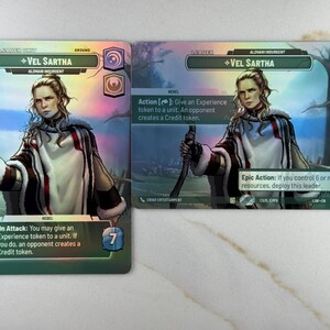May include: Two trading cards featuring the character Vel Sartha. The cards have a portrait of a woman with a bow. The first card has a green background with the text "On Attack". The second card has a blue background with the text "Epic Action".