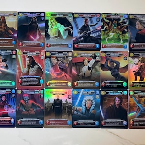 May include: A collection of sixteen Star Wars trading cards featuring various characters. Each card has a unique design with character art, text, and a holographic sheen. The cards are arranged in four rows of four.