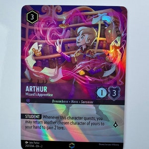 May include: A purple, blue, and gold fantasy trading card featuring a young wizard character named Arthur, Wizard's Apprentice. The card has a 3 power rating, a 1 lore rating, and a student ability. The card text reads: "Whenever this character quests, you may return another chosen character of yours to your hand to gain 2 lore."