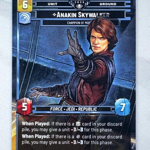 May include: A trading card featuring Anakin Skywalker from the Star Wars universe. The card has a blue and black background with the character's image and game statistics. Text includes "Anakin Skywalker" and "Champion of MOP".
