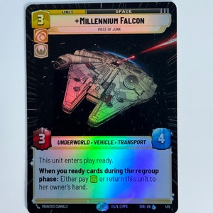 May include: A Star Wars: The Old Republic collectible card game card featuring the Millennium Falcon, a spaceship with a gray and white color scheme. The card is holographic and has a black background. The card text reads "UNIT SPACE ◇MILLENNIUM FALCON PIECE OF JUNK 3 4 UNDERWORLD VEHICLE TRANSPORT This unit enters play ready. When you ready cards during the regroup phase: Either pay 1 or return this unit to her owner's hand. FRANCOIS CANNELS OLFL OFFG SOR-EN 455"