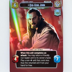 May include: A trading card featuring Qui-Gon Jinn from Star Wars. The card has a portrait of the character holding a green lightsaber. The card includes text such as "Leader Unit", "Student of the Living Force", and game instructions.