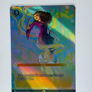 Könnte beinhalten: Eine Fantasy-Sammelkartenspielkarte mit holografischem Finish. Die Karte zeigt eine Frau mit langen braunen Haaren, die ein violettes Kleid trägt. Die Karte trägt den Titel "Revive" und hat einen Kostenpunkt von 5. Der Kartentext lautet "Spiele einen Charakter mit Kosten von 5 oder weniger von deinem Ablagestapel kostenlos."
