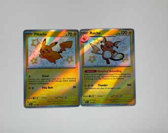 May include: Two holographic Pokemon trading cards featuring Pikachu and Raichu. Pikachu is a basic Pokemon with 70 hit points and Raichu is a stage 1 Pokemon with 120 hit points. Both cards have a yellow and white background with stars and lightning bolts.