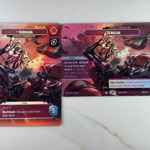 May include: Two trading cards featuring the character Sebulba from a science fiction franchise. The cards have a red and purple colour scheme with illustrations of the character and text describing game actions. The cards are labelled "Hero Unit" and "Leader".