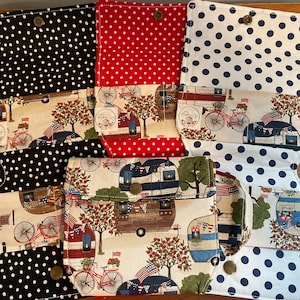 May include: Three fabric wallets with a patriotic theme. Each wallet has a different polka dot fabric on the outside, and a fabric with a vintage camper and bicycle design on the inside. The wallets have a button closure.