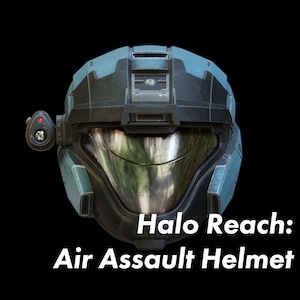 May include: A blue and black Halo Reach Air Assault helmet with a visor and a red light on the side.