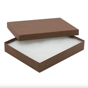 May include: An open brown rectangular gift box with a matching lid slightly ajar. The inside of the box is filled with white packing material. The box is set against a white background.