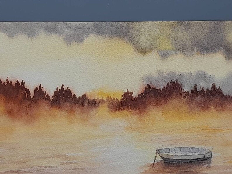 May include: A watercolor painting of a small boat on a lake with a misty background. The sky is a soft yellow and gray, and the trees are silhouetted against the horizon.