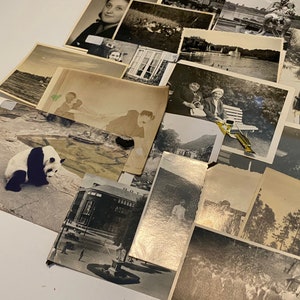May include: A collection of black and white photographs, some with faded colours, featuring a variety of subjects including a panda bear, a group of people, a building, and a lake.