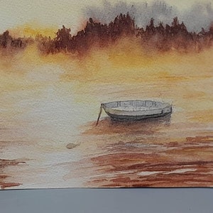May include: A watercolor painting of a small boat on a lake with a misty background. The water is a light brown color and the boat is a light gray color. The background is a light yellow color with a hint of orange.