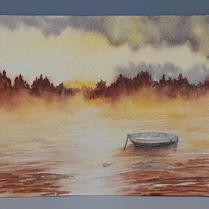 May include: Watercolor painting of a small boat on a lake with a foggy, golden sunset in the background. The trees on the shore are silhouetted against the sky.