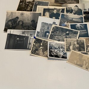 May include: A selection of monochrome vintage photographs, capturing diverse scenes and individuals. The images feature portraits, landscapes, and group photos, providing a nostalgic look at the past. The photographs are displayed on a white surface.