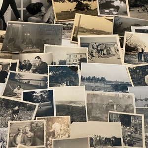 May include: A selection of monochrome photographs, displaying diverse scenes and individuals. The images are arranged in a haphazard manner, presenting a variety of moments and memories captured over time. The photographs vary in size and subject matter.