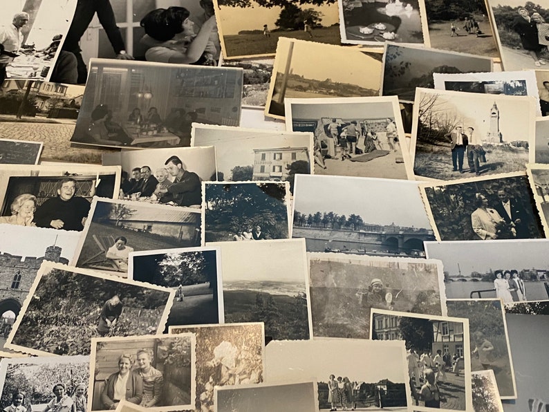 May include: A selection of monochrome photographs, displaying diverse scenes and individuals. The images are arranged in a haphazard manner, presenting a variety of moments and memories captured over time. The photographs vary in size and subject matter.