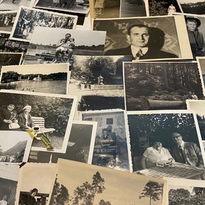 May include: A collection of black and white photographs, some featuring people, some landscapes, and some buildings. The photos are arranged in a random order and are all of different sizes.