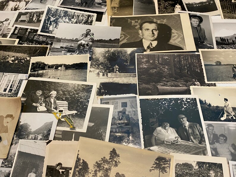 May include: A collection of black and white photographs, some featuring people, some landscapes, and some buildings. The photos are arranged in a random order and are all of different sizes.