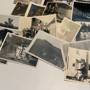 Puede incluir: Una colecci&oacute;n de fotograf&iacute;as antiguas en blanco y negro, algunas con personas, otras con paisajes y otras con edificios. Las fotos est&aacute;n dispuestas en una pila sobre una superficie blanca.