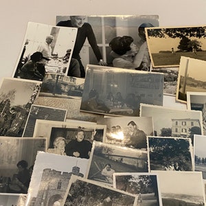 May include: A collection of vintage black and white photographs, depicting various scenes. The images show people, landscapes, and buildings, creating a nostalgic feel. The photographs are arranged in a layered composition.