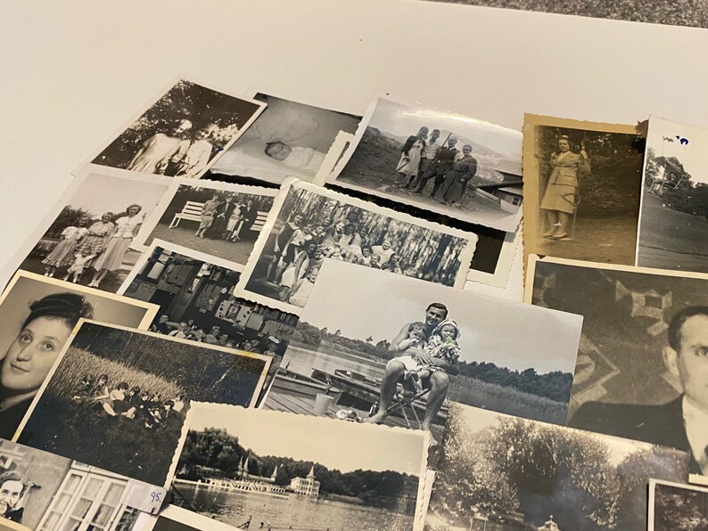May include: A collection of black and white photographs, some featuring people, some landscapes, and some buildings. The photos are arranged in a random order and are all of different sizes.