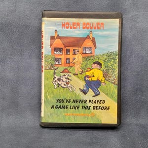 Puede incluir: Cartucho de juego Commodore 64 vintage para "Hover Bovver". La portada presenta una ilustración de dibujos animados de una casa, un hombre cortando el césped y un perro. El texto dice "You've never played a game like this before."