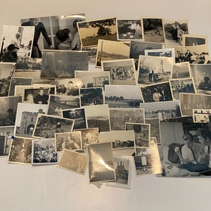 May include: A collection of monochrome photographs, closely arranged. The images show diverse scenes, including people, landscapes, and buildings. The photographs vary in size and shape, creating a nostalgic display of memories.