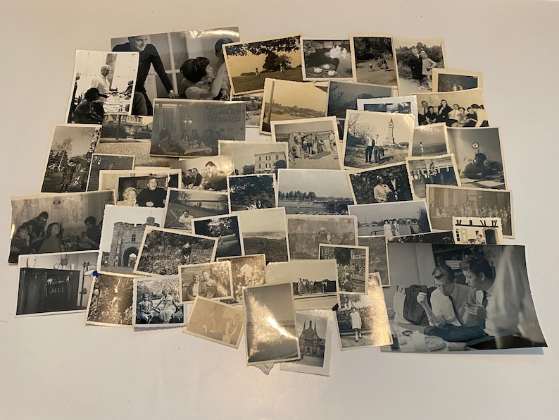 May include: A collection of monochrome photographs, closely arranged. The images show diverse scenes, including people, landscapes, and buildings. The photographs vary in size and shape, creating a nostalgic display of memories.