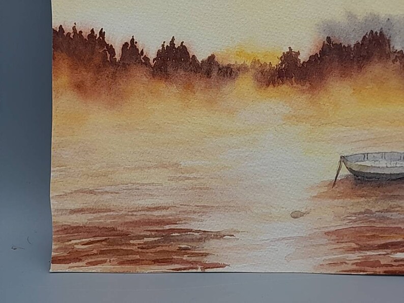 May include: A watercolor painting of a small boat on a calm lake with a misty, golden sunset in the background.