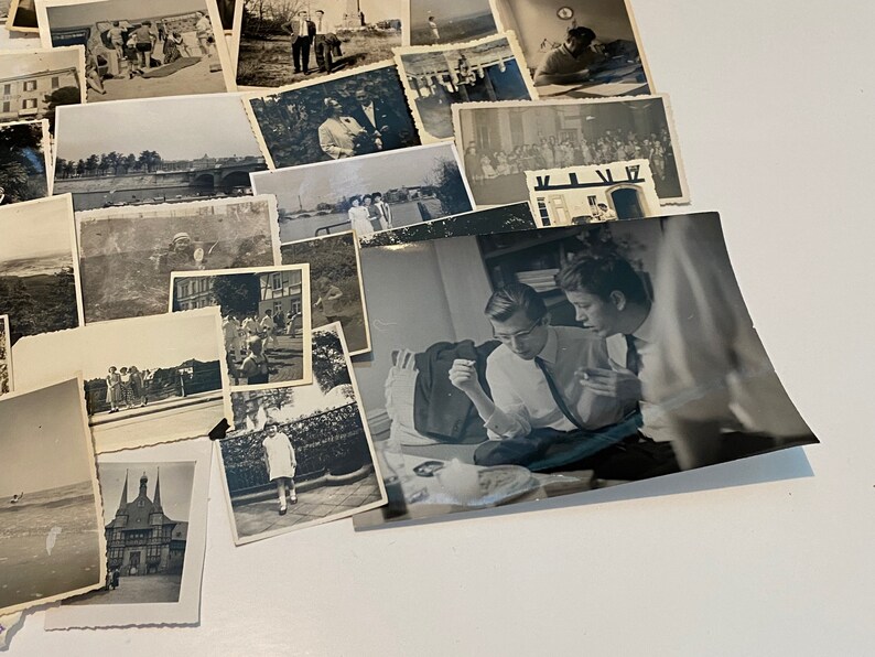 May include: A selection of monochrome photographs, capturing diverse scenes. The images feature people, architecture, and natural landscapes. Some photos show individuals in formal wear, while others depict informal outdoor activities.