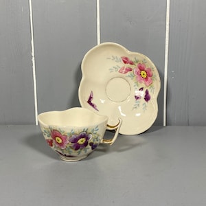 Hand-Painted Ceramic Tea Cup and Saucer with Gold Gilt Handle.