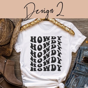 May include: White t-shirt with a black graphic design of the word "HOWDY" repeated in a wavy pattern.