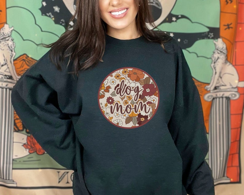May include: A black sweatshirt with a floral design and the text "dog mom" in a circle.