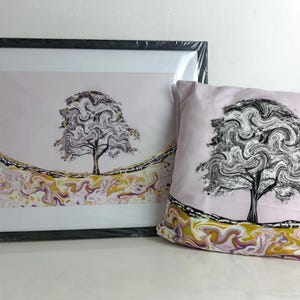 May include: A framed print and a cushion with a black and grey tree design on a pale pink background. The base of the artwork and cushion feature a colourful, swirling pattern. The items are decorative and suitable for home decor.