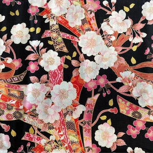 May include: Black fabric with a repeating pattern of pink and white cherry blossoms and gold and red ribbons.