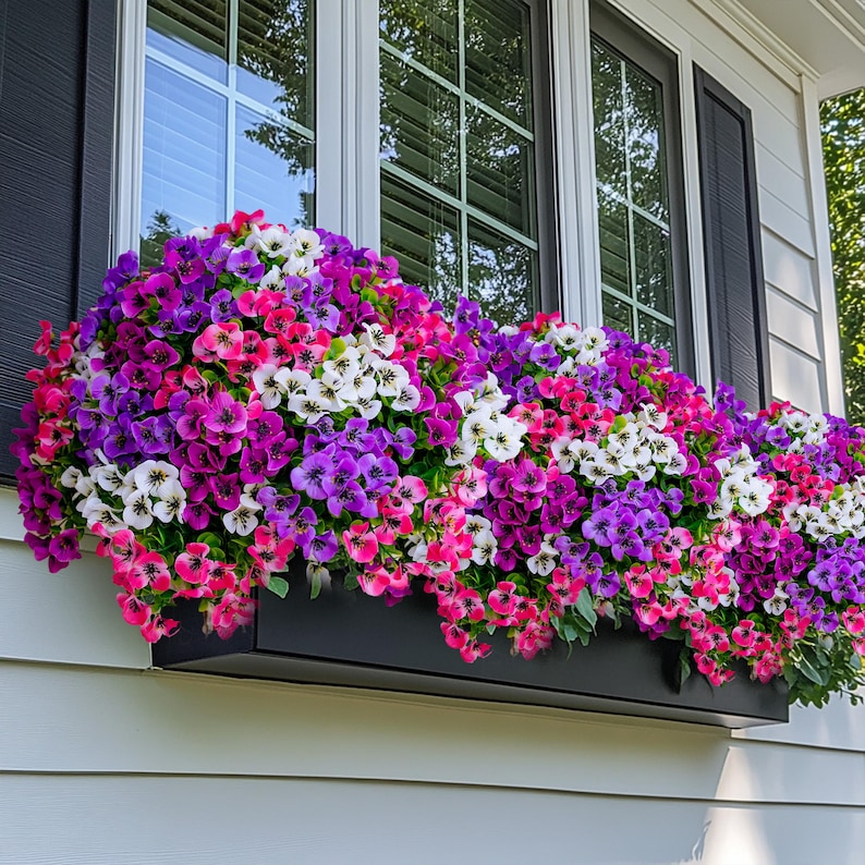 May include: A window box overflowing with pink, purple, and white flowers. The flowers are in full bloom and create a beautiful display.
