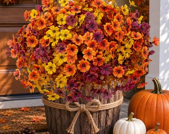May include: A large, dense arrangement of artificial flowers in shades of yellow, orange, and deep purple, housed in a cylindrical, bark-textured container wrapped with a thick, natural-colored jute rope tied into a decorative bow at the front.