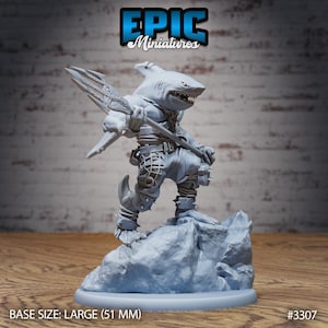 May include: A gray, detailed miniature of a shark-like creature holding a trident. The creature is standing on a gray rock base. The base is 51 mm in diameter. The miniature is labeled "EPIC Miniatures #3307".