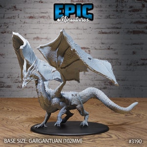 May include: A white, detailed dragon miniature with wings spread wide. The dragon is standing on a black base. The base size is gargantuan (102mm). #3190