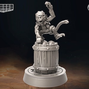 May include: A gray, detailed miniature figurine of a monkey wearing a bandana and holding a barrel with a lid. The monkey is standing on a round base.