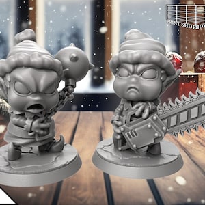 May include: Two grey painted figurines of elves wearing Santa hats. One elf holds a spiked ball on a chain and the other holds a chainsaw.