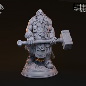 May include: A detailed, gray figurine of a muscular, bearded warrior holding a large hammer. The figure is clad in armor and fur, with pouches and belts. The base is a circular platform. The Print Shop Boys Berlin logo is visible.