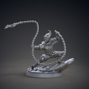 May include: A gray, detailed miniature figurine of a warrior wielding a chain weapon. The figure is posed in a dynamic action stance, with the chain weapon extended and the figure's legs spread apart. The figure is standing on a small, rocky base.