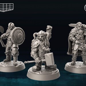 May include: Three miniature figurines of dwarves, each with a different weapon and pose. The dwarf on the left is holding an axe and shield, the middle dwarf is holding a hammer, and the dwarf on the right is holding a sword. The figurines are painted in a gray color and are standing on circular bases.
