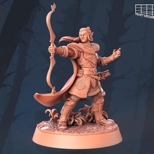 May include: A 3D-printed miniature of an archer elf, with a drawn bow. The figure is in a dynamic pose, wearing armour and a flowing cape. The base is textured with foliage. The miniature is a light brown colour.