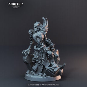 May include: A gray 3D printed miniature of a skeletal figure with a flowing robe and a skull head. The figure is standing on a rocky base with skulls.